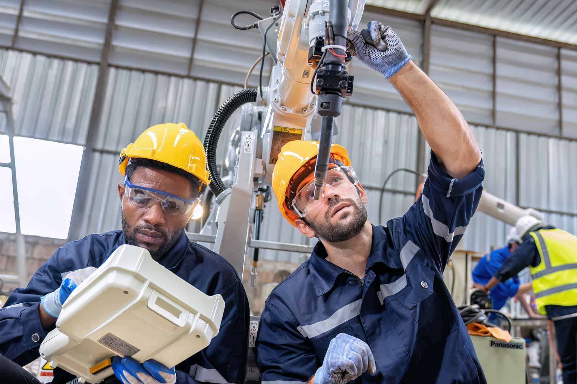 maintenance-engineer-repair-and-programing-robotic-arm-in-factory-industry-robot-service-shop-1.jpg